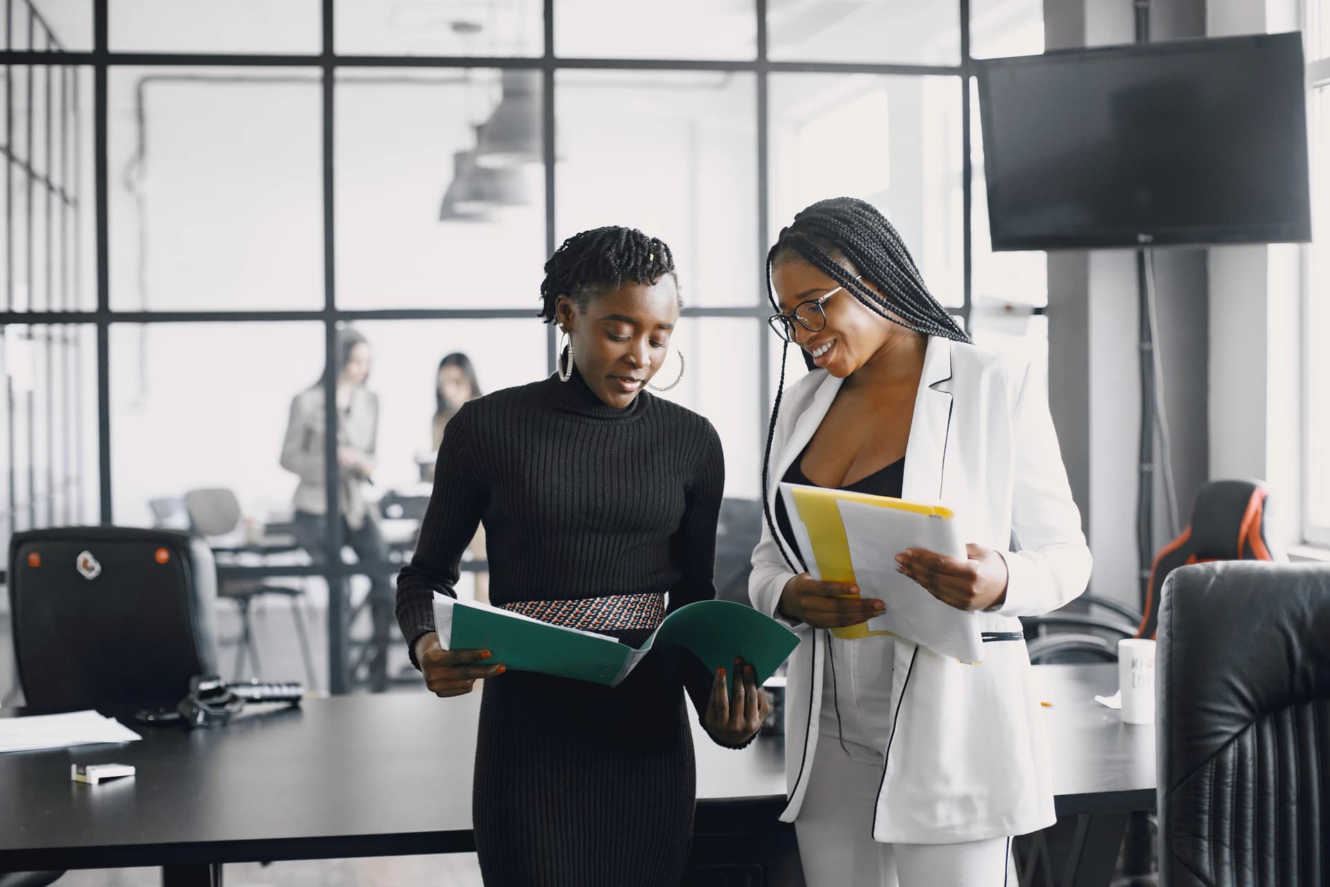 Two professionals reviewing documents together in an office